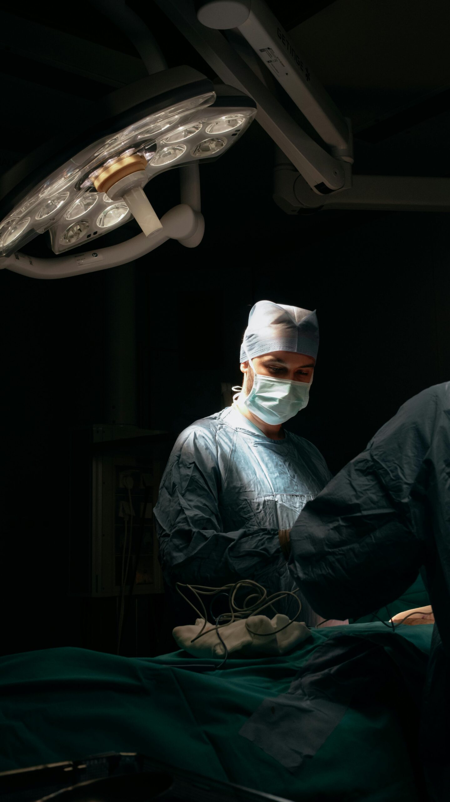 A surgeon in the operating room with another person.