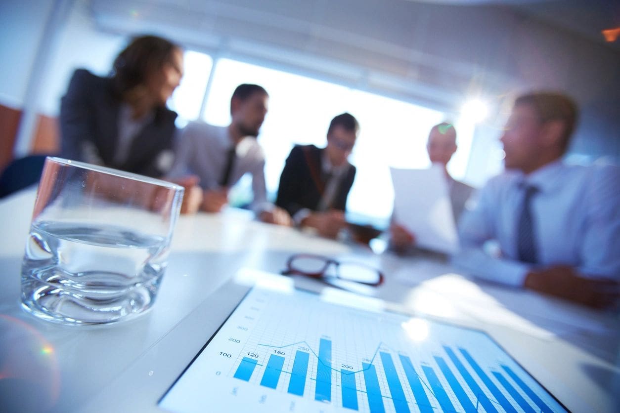 Business meeting with charts and papers.