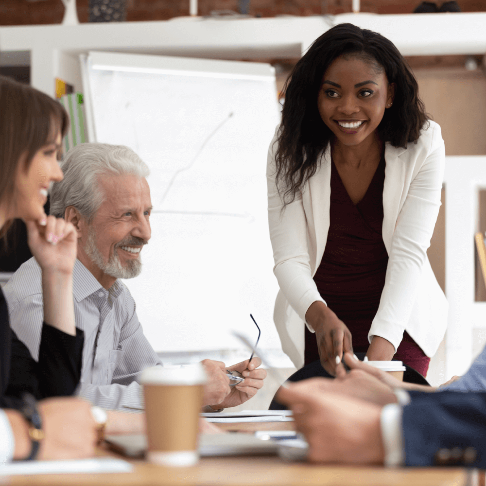 Team meeting with smiling participants in office.
